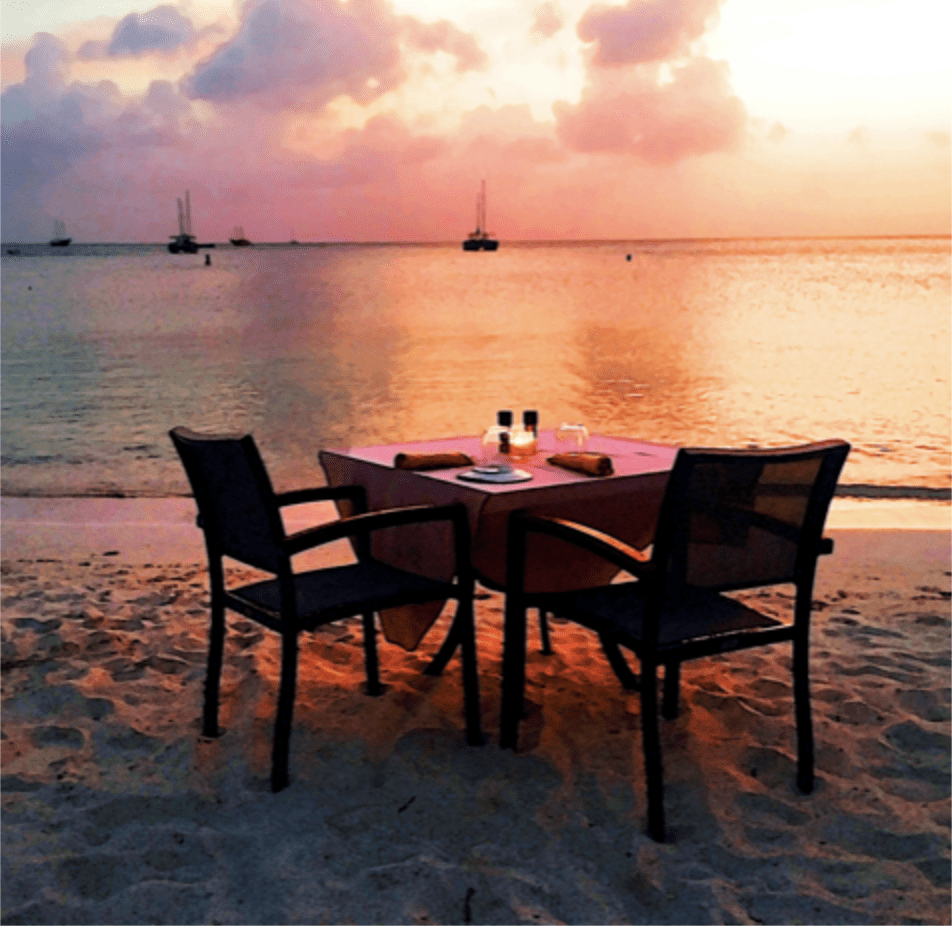 romantic sunset set up for dinner at the beachside in Aruba